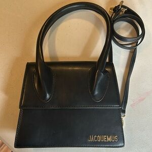 Black handbag with gold hardware and cross body strap